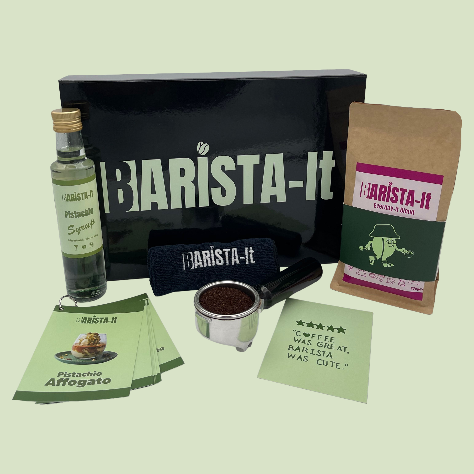 Collection of Pistachio Barista-it Coffee products including a black box, Syrup bottle and recipe cards.