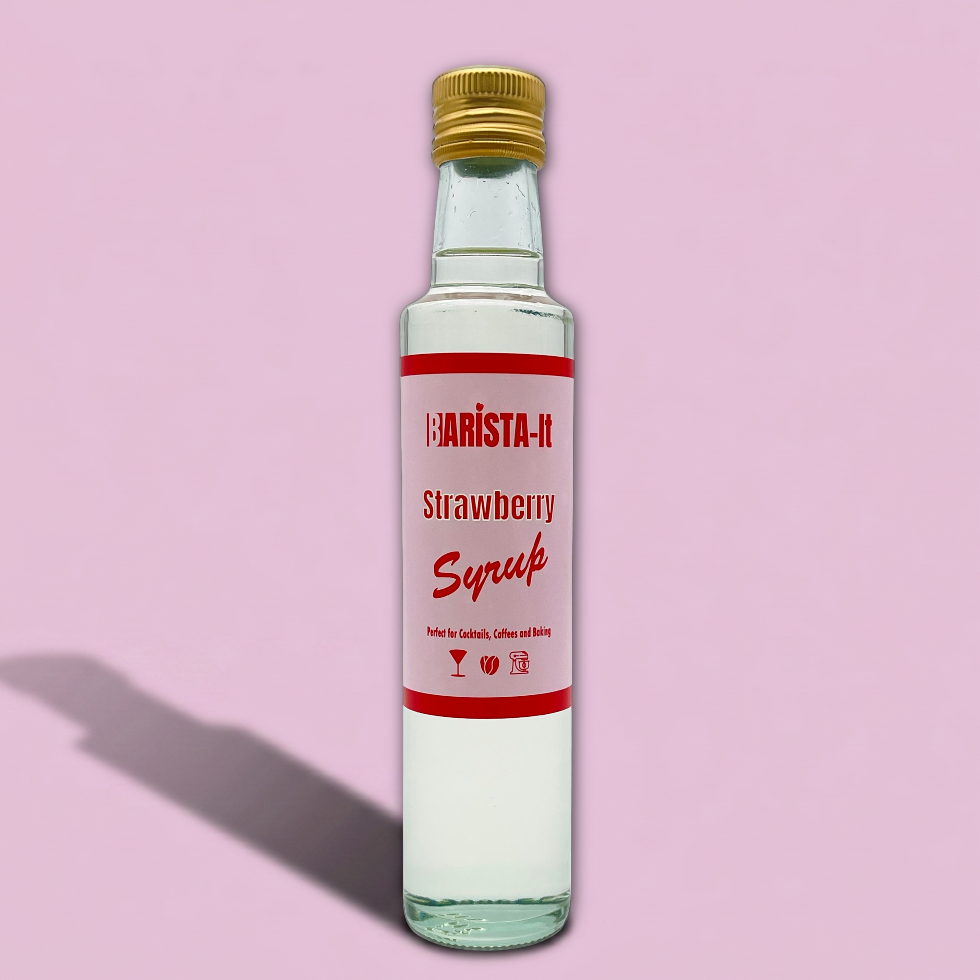 Bottle of Barista -It Strawberry Syrup on a pink background