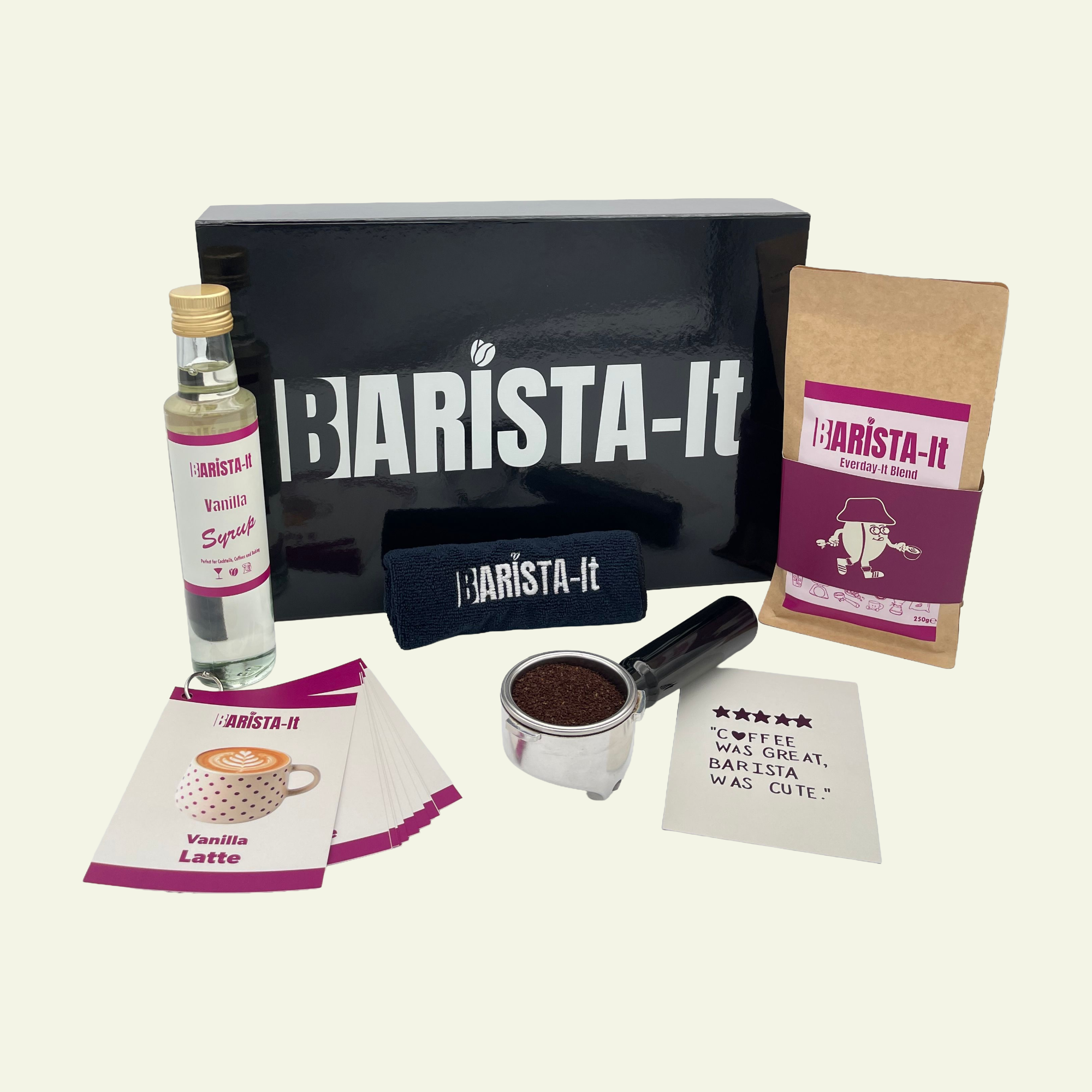 Collection of Vanilla Barista-it coffee products including a black box, Syrup bottle and recipe cards.