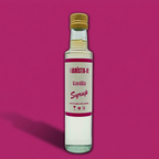 Bottle of Barista-It Vanilla Syrup on a Pink background.