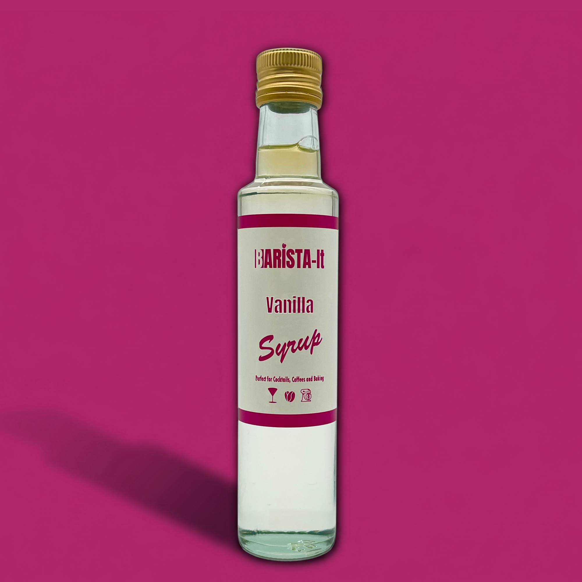 Bottle of Barista-It Vanilla Syrup on a Pink background.